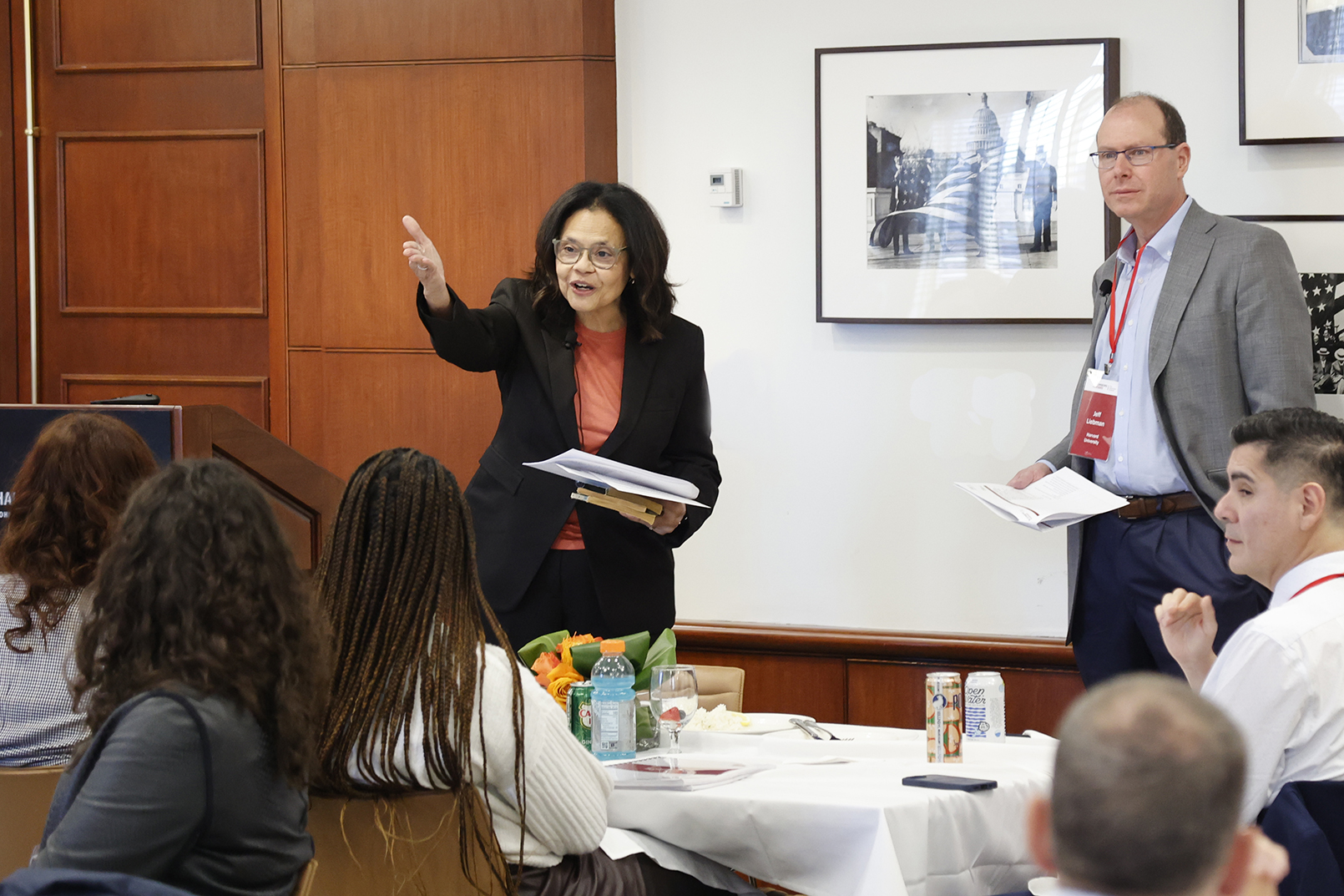 Two faculty members speaking in front of students.