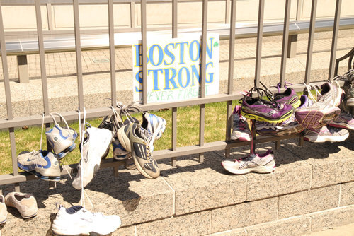 Boston Strong sign surrounded by running shoes