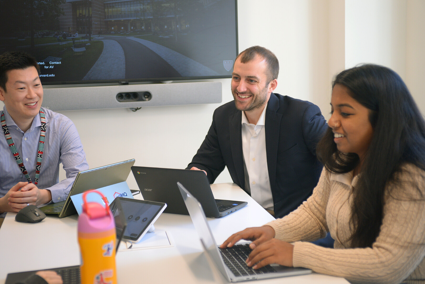 students working together at a table with computers