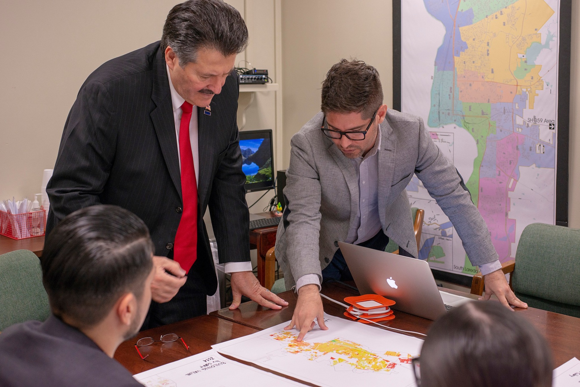 Mayor and team work at a table and looking over charts